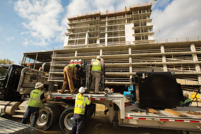 MGE crews unload a large electric transformer to help power a new high-rise development with 244 apartments.