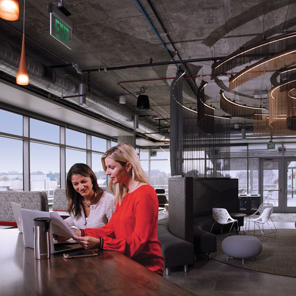 Gaby Frazer, COO, and Darcey Nett, CEO, both of ImageMoverMD, meet in the café at the entrepreneurial hub StartingBlock Madison. The start-up software company received financing through the Venture Debt Fund, which helps grow emerging high-tech companies.