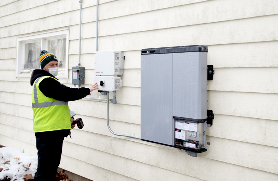 MGE employee checking residential battery