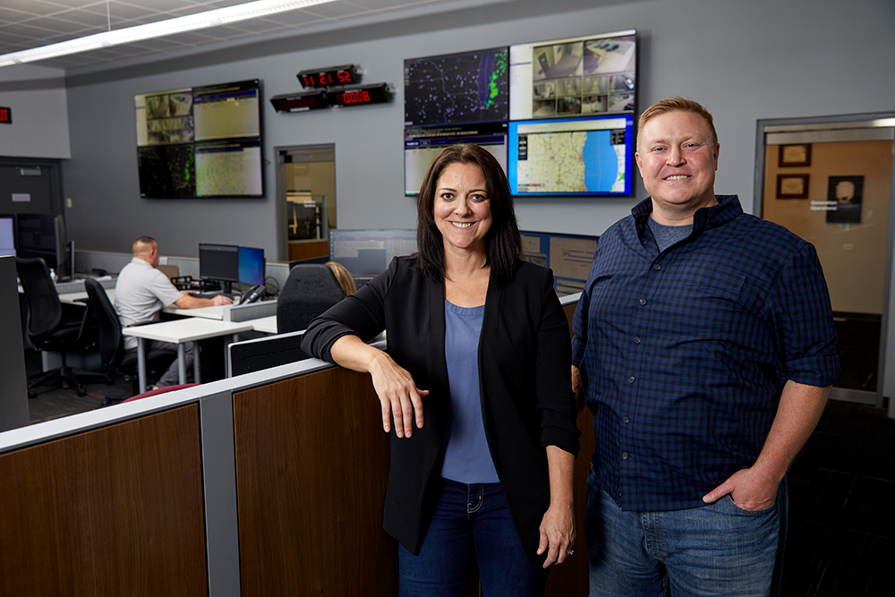 Tiffany Nolden, Director IT Security, and Dom Sopkovich, Director Enterprise Systems, stand in MGE’s Distribution Operations Center, the “nerve center” of MGE’s electric and gas systems.