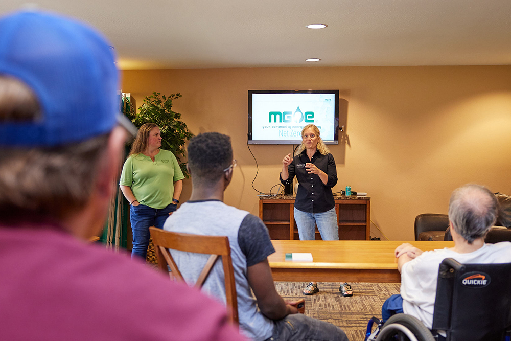 MGE Residential Energy Engineer Laura Paprocki shares energy-saving strategies with residents of an affordable housing complex for students and households with limited-to-moderate incomes.