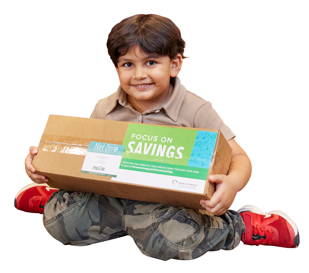 Little boy holding the Focus on Savings box from Focus on Energy