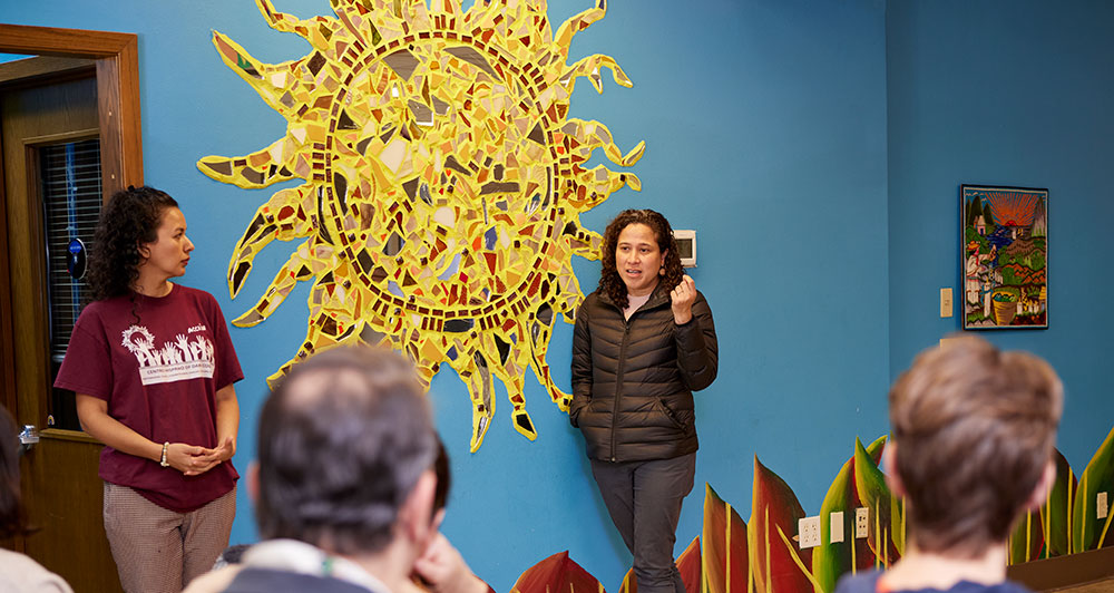 Dr. Karen Menéndez, Executive Director of Centro Hispano, talking to a group at the center