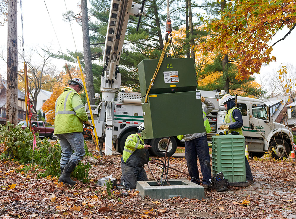 MGE crew members install a pad-mount transformer