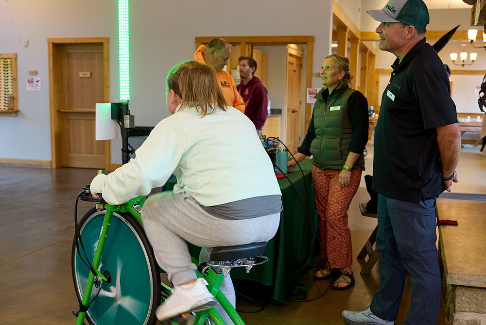 A student uses the MGE Pedal Power Bicycle at an event at the Aldo Leopold Nature Center