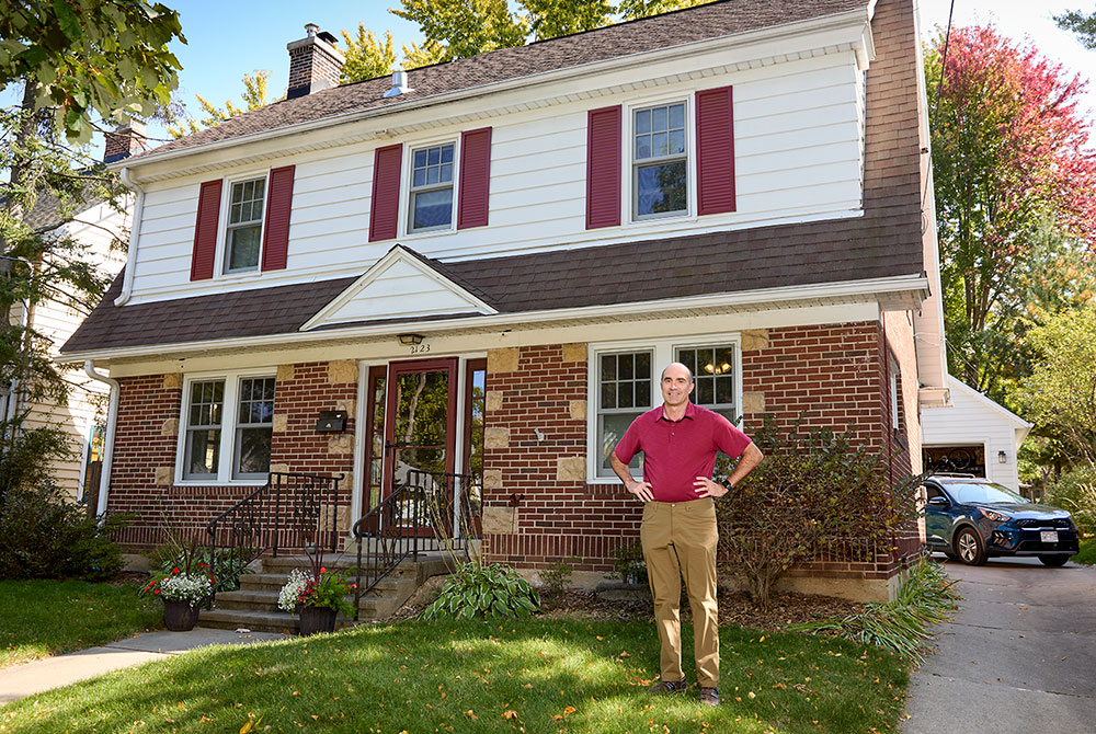 MGE customer Andrew Held standing outside in front of his home