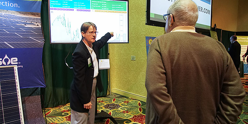 MGE's Laura Williams describes a solar energy production graph at the annual meeting