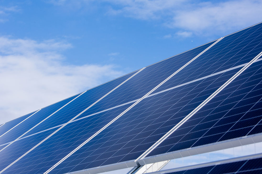 close-up of a solar panel array with a blue sky in the background
